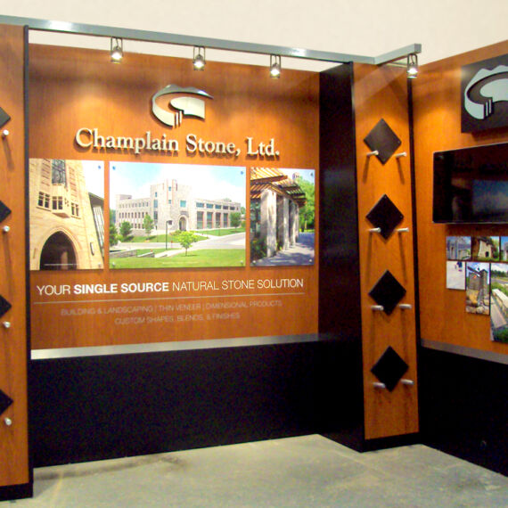 Trade show booth exhibit for Champlain Stone with track lighting, monitor and graphics