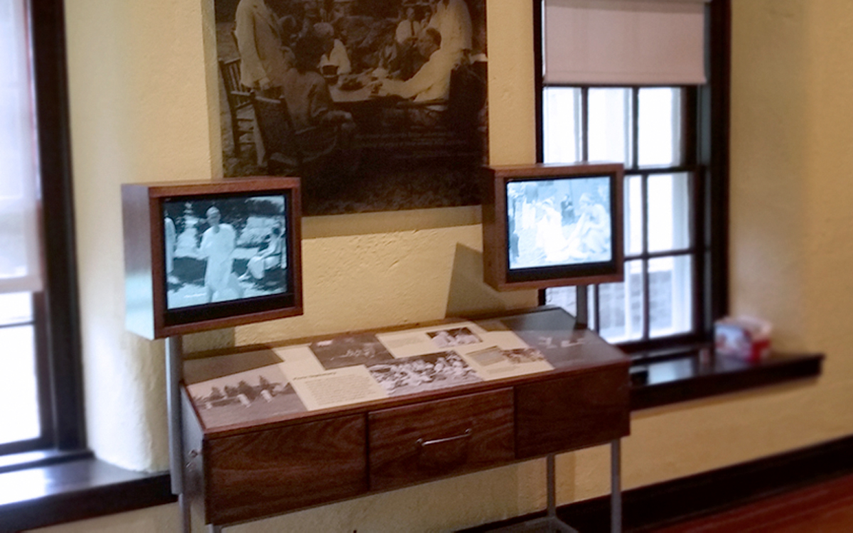 Custom interactive kiosk and display case with two monitors that play videos about FDR's life in the Eleanor Roosevelt Cottage