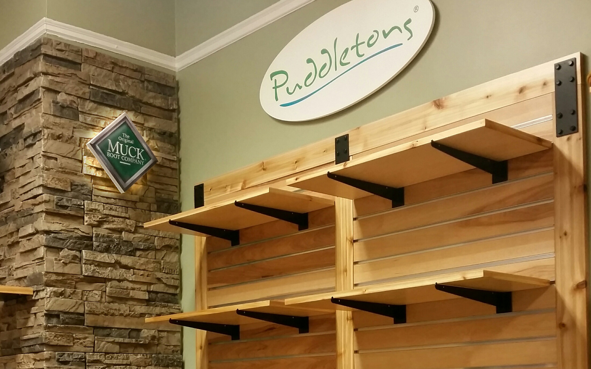 Custom product display with rustic store fixtures for Muck Boots