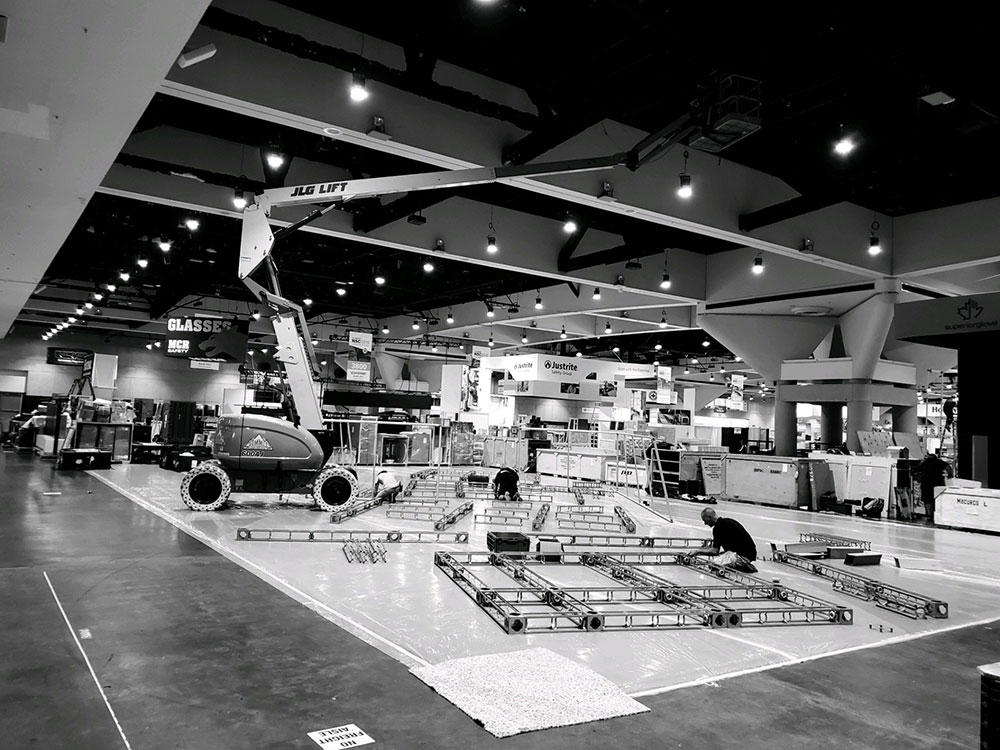 convention hall installation of trade show booth with crane